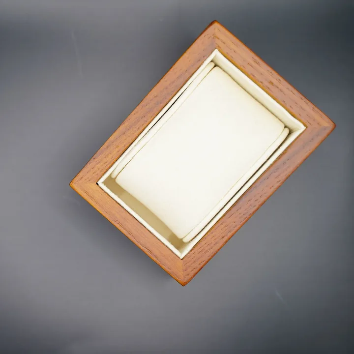 Typ.A beige watch case on a dark surface