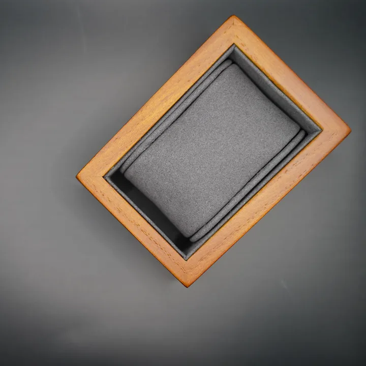 Typ.A grey watch case on a dark surface